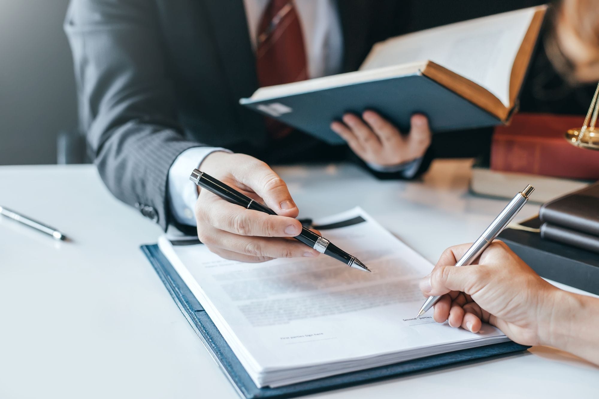 Man Holding a Pen and a Book